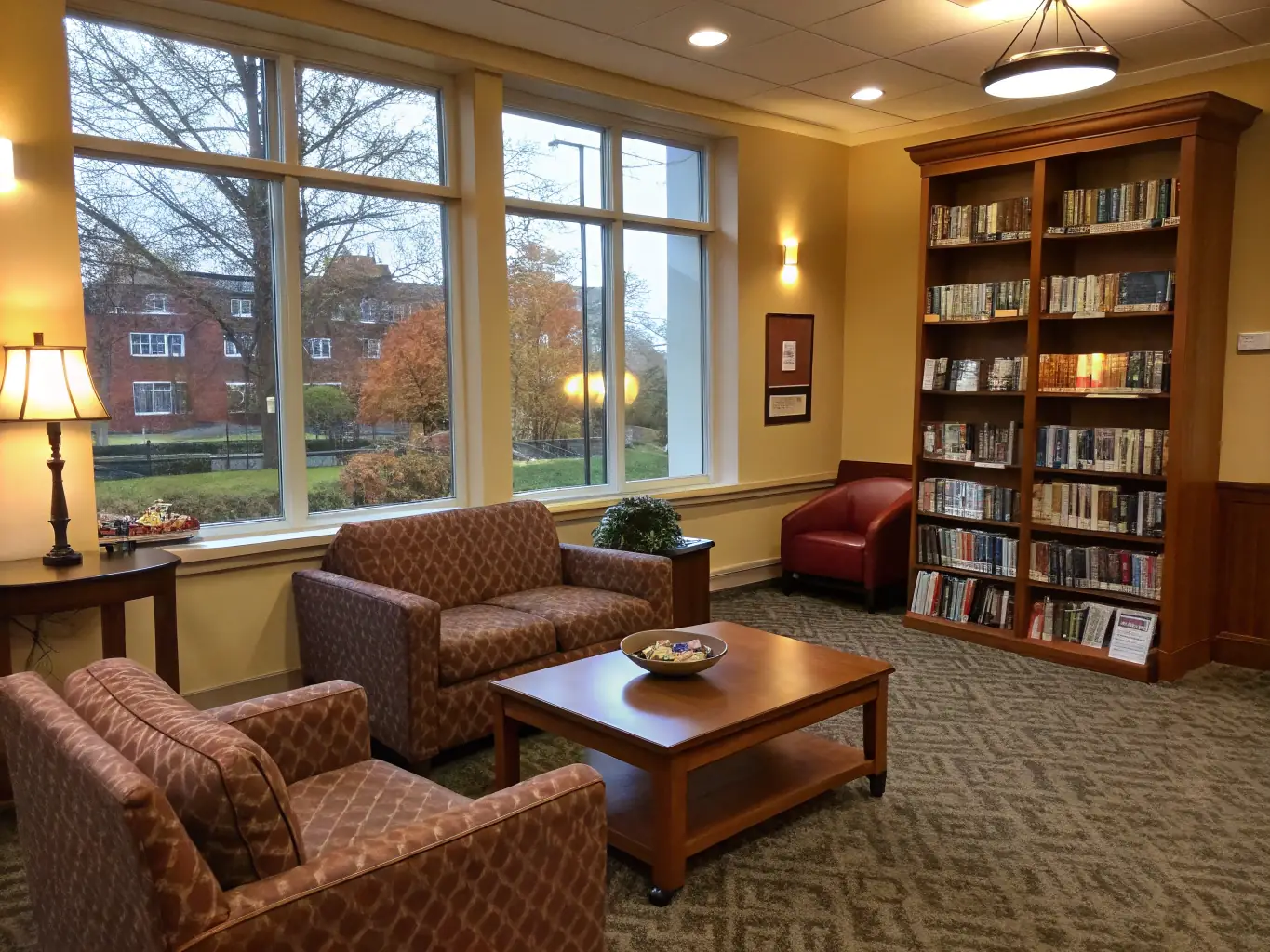A photograph of students in one of the boarding houses' common rooms, studying together and interacting with each other, showcasing the sense of community and support within the boarding environment.